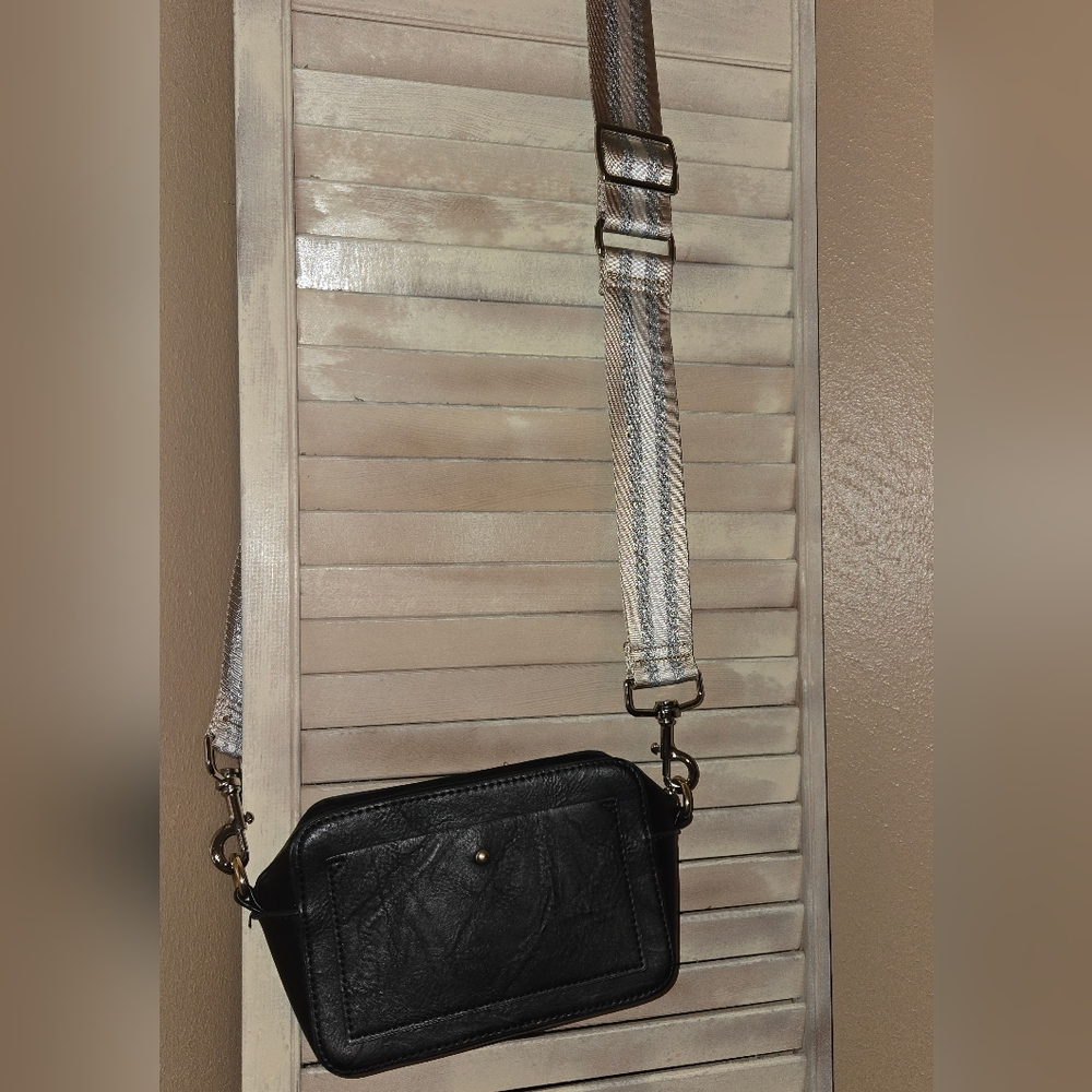 Ah.dorned Black Leather Crossbody Bag with Striped Strap.